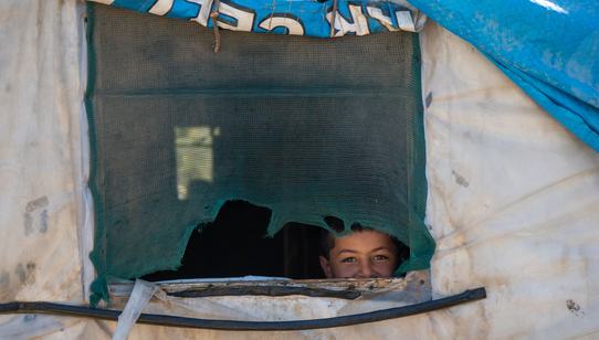 Kind dat uit het raam van hun tent gluurt in Lebanon_War Child_201006